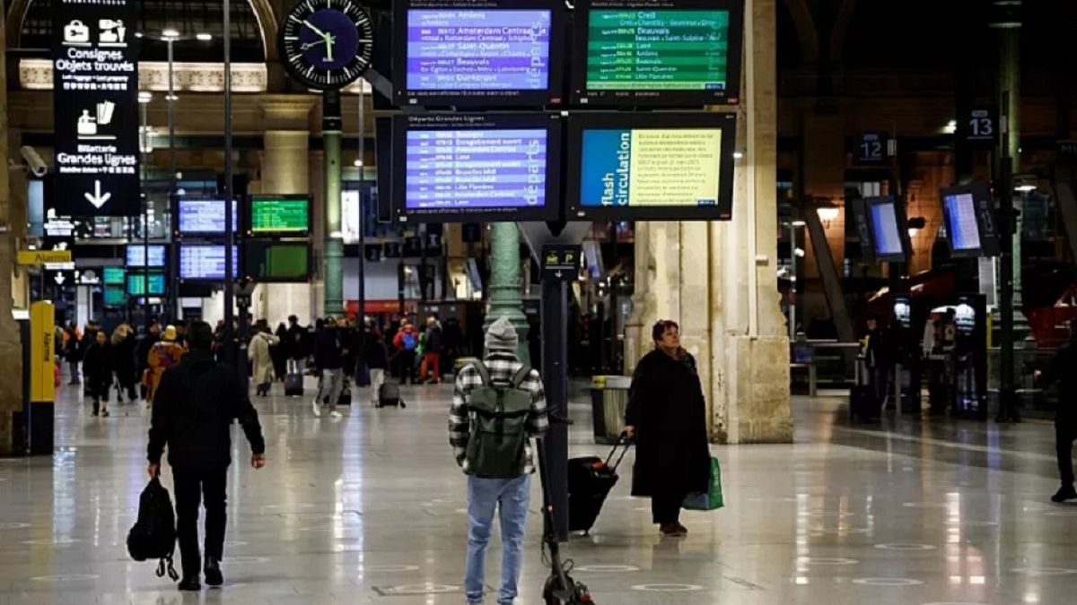 Travellers walks at Gare du Nord train station in Paris on a new day of nationwide strikes and protests against the government's pension reform plan on March 23.