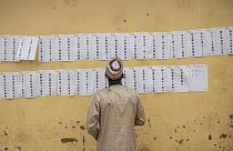 A voter looks for his name on the voters roll at a polling station in Abuja on February 25, 2023, during Nigeria's presidential and general election.