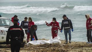 Rescuers recover a body at a beach near Cutro, southern Italy, after a migrant boat broke apart in rough seas.