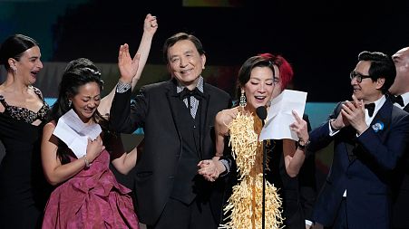 From left: Jenny Slate, Stephanie Hsu, James Hong, Michelle Yeoh, and Ke Huy Quan accept the SAG award for outstanding performance by a cast in a motion picture.