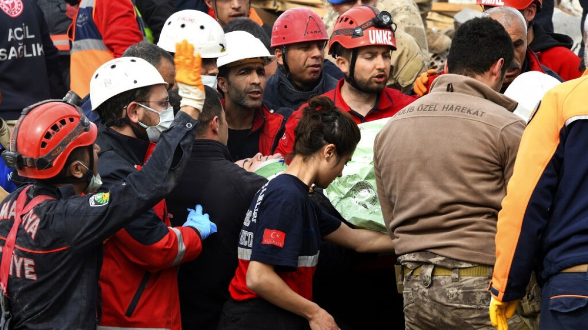Rescue workers carry a girl pulled out from a collapsed building to an ambulance, in Malatya, Turkey, Monday, Feb. 27, 2023. 