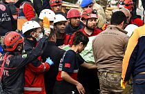 Rescue workers carry a girl pulled out from a collapsed building to an ambulance, in Malatya, Turkey, Monday, Feb. 27, 2023.