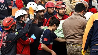 Rescue workers carry a girl pulled out from a collapsed building to an ambulance, in Malatya, Turkey, Monday, Feb. 27, 2023. 