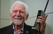 Marty Cooper, the inventor of first commercial mobile phone, poses for the press with a Motorola DynaTAC 8000x