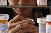 Photo illustration of teenager looking through medication in home cabinet, March 11, 2010.