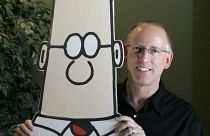 Scott Adam’s poses with his cartoon creation Dilbert