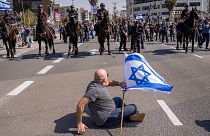 Mounted police are deployed as Israelis block a main road to protest against plans by Prime Minister Benjamin Netanyahu's new government to overhaul the judicial system.