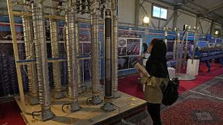 A student looks at Iran's domestically built centrifuges in an exhibition of the country's nuclear achievements, in Tehran, Iran, Wednesday, Feb. 8, 2023. 