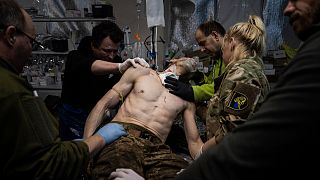 Ukrainian military medics treat their wounded comrade at the field hospital near Bakhmut, Ukraine, Sunday, Feb. 26, 2023.
