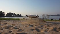 The quadruped robot RaiBo running on a beach in South Korea.
