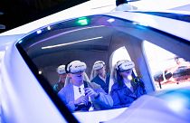 Visitors test a SK Telecom VR flight simulator during the Mobile World Congress 2023 in Barcelona, Spain