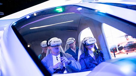 Visitors test a SK Telecom VR flight simulator during the Mobile World Congress 2023 in Barcelona, Spain