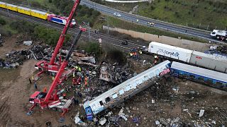 Cranes remove debris after a collision in Tempe, about 376 kilometres (235 miles) north of Athens, near Larissa city