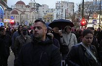 Manifestantes respeitam minuto de silêncio por vítimas de acidente ferroviário durante protesto em Atenas