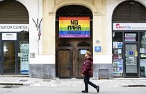 A man walks past a flag that reads: "No Mafia" in Palermo, Italy.