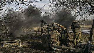 Ukrainian soldiers fire at Russian positions