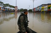 A Malaysian soldier looks out over flood waters in Kota Tinggi, Malaysia's Johor state.