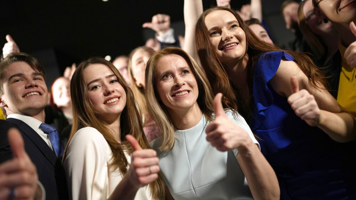 Members of the Reform Party and supporters of Prime Minister Kaja Kallas, centre, pose for photo in Tallinn, Estonia, Sunday, March 5, 2023. 