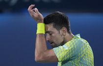 Serbia's Novak Djokovic reacts after he lost a point against Daniil Medvedev during their semi final match of the Dubai Duty Free Tennis Championships in Dubaii, UAE