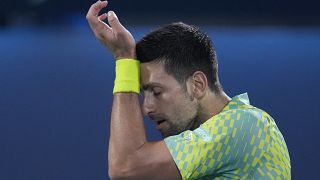 Serbia's Novak Djokovic reacts after he lost a point against Daniil Medvedev during their semi final match of the Dubai Duty Free Tennis Championships in Dubaii, UAE
