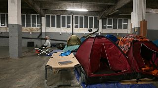 In a Paris parking lot, migrants survive out of sight