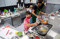 Children use a gas hob during a US cooking class in 2020.