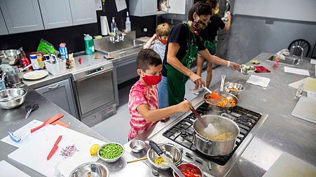Children use a gas hob during a US cooking class in 2020.