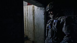 A Ukrainian serviceman looks out of a shelter in Chasiv Yar, Donetsk region, Ukraine, Monday, March 6, 2023.