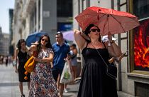 A woman shelters from the sun during a hot sunny day in Madrid, Spain, 18 July 18 2022.