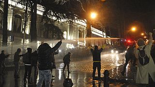 The police fire water cannon at protesters outside the Georgian parliament building in Tbilisi, Georgia, Tuesday, March 7, 2023.