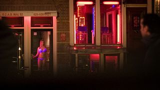 FILE: Sex workers are seen in the Red Light district of Amsterdam, Netherlands, Sunday, Dec. 7, 2008. 