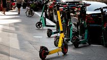 Rental electric scooters are seen on a sidewalk in Paris.