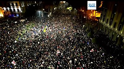 Protesters gather outside the Georgian parliament building in Tbilisi, Georgia.