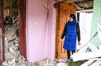A woman searches the rubble of the destroyed house of her relatives following a Russian strike in the village of Velyka Vilshanytsia, near Lviv, Ukraine. March 9, 2023.