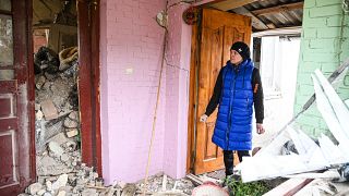 A woman searches the rubble of the destroyed house of her relatives following a Russian strike in the village of Velyka Vilshanytsia, near Lviv, Ukraine. March 9, 2023.