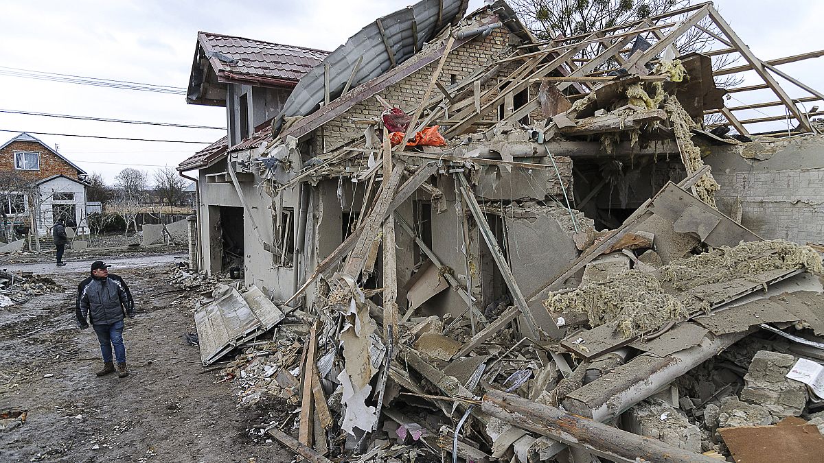 Villagers clear the rubble after Russia's night rocket attack ruined private houses in the Lviv region, Ukraine. March 9, 2023 