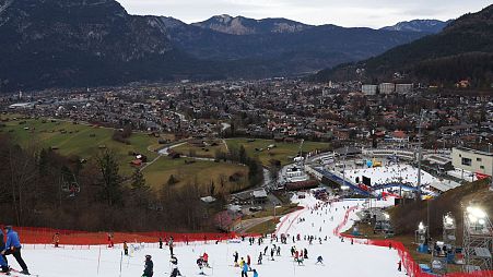 Competitors inspect the small strip of snow where they will compete in an alpine ski, men's World Cup slalom race, in Garmisch Partenkirchen, Germany, Wednesday, Jan. 4, 2023.