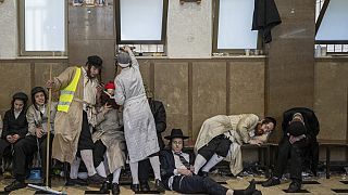 Ultra-Orthodox Jewish men celebrate after getting drunk during the Jewish holiday of Purim in Mea Shearim ultra-Orthodox neighborhood in Jerusalem, Wednesday, March 8, 2023.