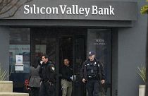 Santa Clara Police officers exit Silicon Valley Bank headquarters in Santa Clara, California, Friday, March 10, 2023, after it collapsed.