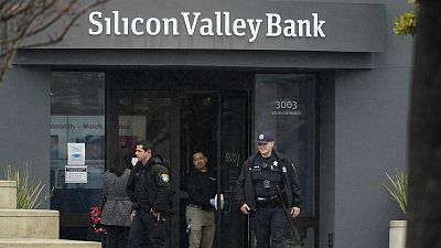 Santa Clara Police officers exit Silicon Valley Bank headquarters in Santa Clara, California, Friday, March 10, 2023, after it collapsed.