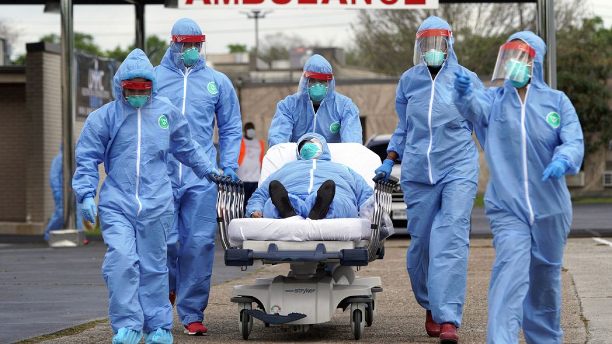 A person is taken on a stretcher into the United Memorial Medical Center after going through testing for COVID-19 Thursday, March 19, 2020, in Houston