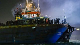 A fishing boat with some 500 migrants enters the southern Italian port of Crotone, early Saturday, March 11, 2023