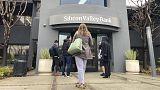 People stand outside of an entrance to Silicon Valley Bank in Santa Clara, California, 10 March 2023