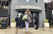 People stand outside of an entrance to Silicon Valley Bank in Santa Clara, California, 10 March 2023