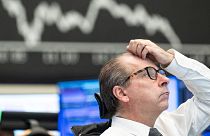 A stock exchange trader observes the price development at the German Stock Exchange in Frankfurt, Germany, Monday, March 13, 2023.