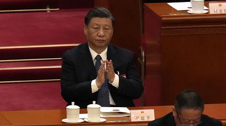 Chinese President Xi Jinping applauds during a session of China's National People's Congress (NPC) at the Great Hall of the People in Beijing, Sunday, March 12, 2023. 
