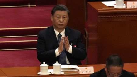 Chinese President Xi Jinping applauds during a session of China's National People's Congress (NPC) at the Great Hall of the People in Beijing, Sunday, March 12, 2023.