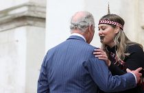 Britain's King Charles III is greeted upon arrival by a member of the Ngati Ranana London Maori Club at Westminster Abbey, in London, on March 13, 2023.