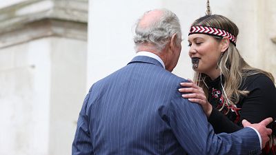 Britain's King Charles III is greeted upon arrival by a member of the Ngati Ranana London Maori Club at Westminster Abbey, in London, on March 13, 2023.