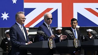 President Joe Biden, center, speaks as Australian Prime Minister Anthony Albanese, left, and British Prime Minister Rishi Sunak listen at Naval Base Point Loma, 13 March 2023